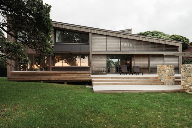 The horizontal screens contrasts with the vertical cedar cladding and provides mass to the lower part of the façade.