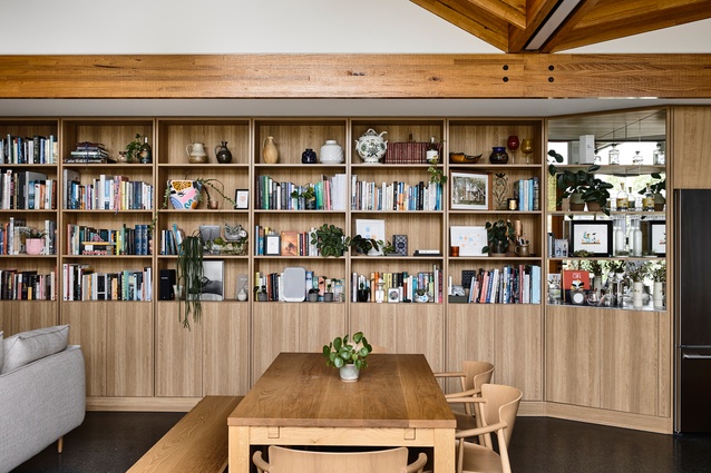 The southern spine of Garden House by BKK Architects is entirely shelves, displaying books and a collection of ceramics.