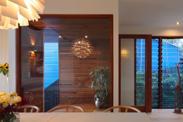 In the dining space, louvred windows help with airflow inside. 