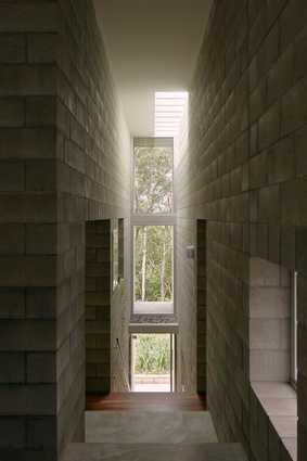 A continuous, stepped corridor forms the spine of the house.
