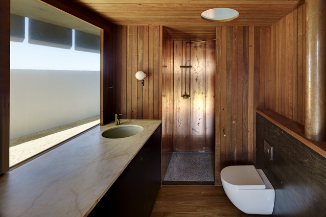 Timber, copper and marble come together to create a sense of luxury and warmth in one of the bathrooms.