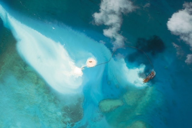In its natural state, Fiery Cross Reef on the west side of the Spratly Islands is submerged at high tide, with the exception of two rocks.