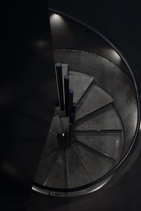 The submarine metaphor continues into the interior, with a spiral staircase executed with military precision, and with military materials.