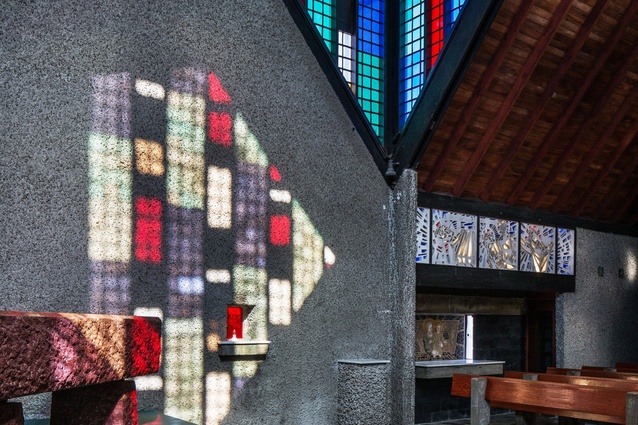 Multi-paned gables of coloured Perspex throw a tapestry of colour over the chapel’s roughcast concrete walls.