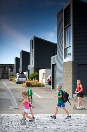A shared driveway between Boardwalk Lane units functions as a safe streetscape for children to play.