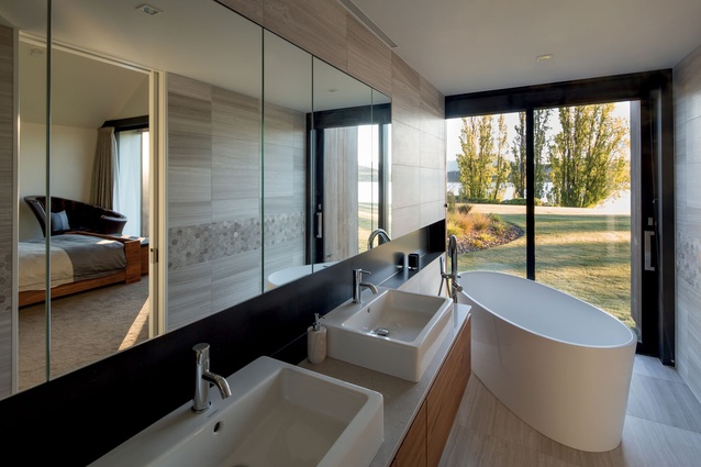 The main bathroom features a freestanding tub with a view of Lake Wanaka.