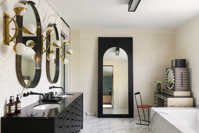 The Triple Orb wall sconces in the master bathroom are from Charles Burnand in London and the vanity mirrors and dressing table are both designed by Wearstler.