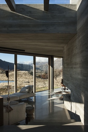 Queenstown home. A large skylight, cut through the concrete and earth above, allows natural light to penetrate into the interior of the house.