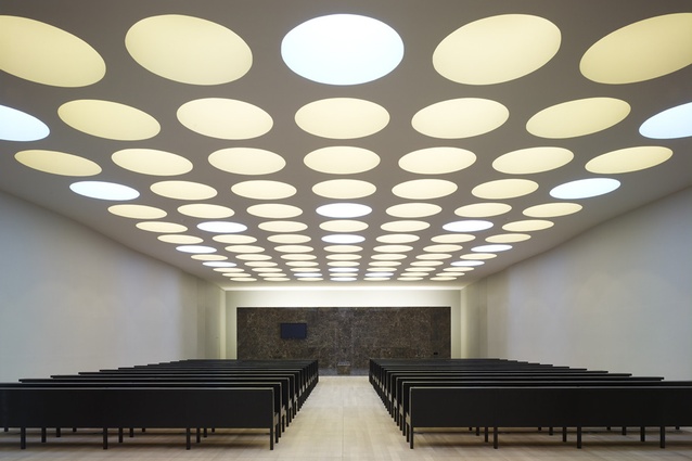 Crematorium Heimolen. In the ceremonial room, the perforation of the ceiling with large round lights reinforces the respectful, calm atmosphere.