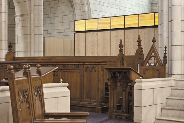 The chapel's vertical oak paneling contrasts with the horizontal stone coursework.