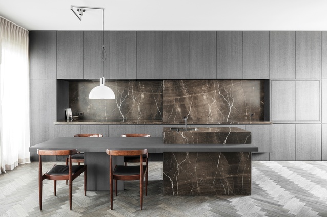 City Loft G’s kitchen in Antwerp by Aajaan De Feyter is restrained but maintains a drama through dark finishes highlighting the joinery, flooring and sculptural island.