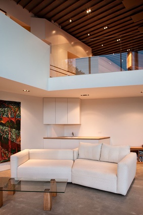 The double-height void in the living area reinforces the nautical theme of the home.