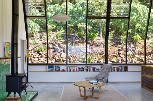 A south-facing glass wall aligns with a hillside garden to create what the architect describes as a “living painting.”