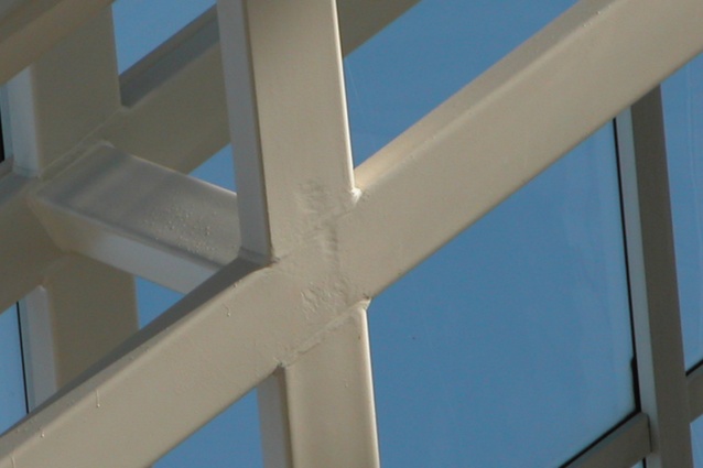 This welded connection is located high up in an atrium and since it will not be seen it has not been filled to be smooth before painting, reducing costs.