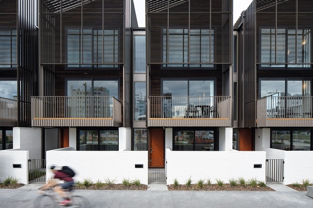 The townhouses are viewed from the shared space and walkway of adjacent Rauora Park.