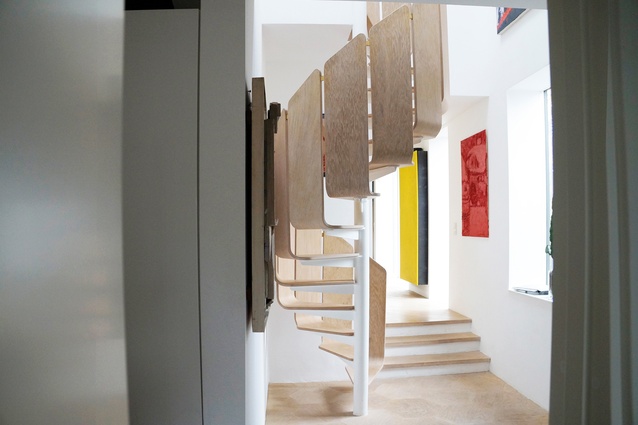 The home-owners also designed the living room’s sinuous bentwood-inspired staircase, which coils up towards the bedrooms on the second floor.
