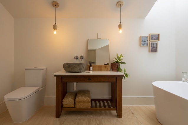 The vanity is created from a second hand hall stand topped with a kitchen bench off-cut.
The stone basin is from Bali, purchased from a local homewares store.