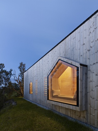 A south-facing perforated window filters light while ensuring that the gable end views are the main focus.