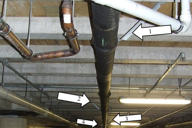 An NZS4219:2009 non-compliant pipe carrying high-pressure town supply water into a building. It has only four transverse restraints; to comply with even the NZS4219:1983 standard this run of pipe would need eight transverse seismic restraints and three longitudinal seismic restraints.