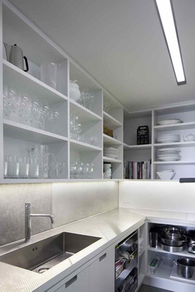 The scullery kitchen sits behind the tall wall of cupboards. 