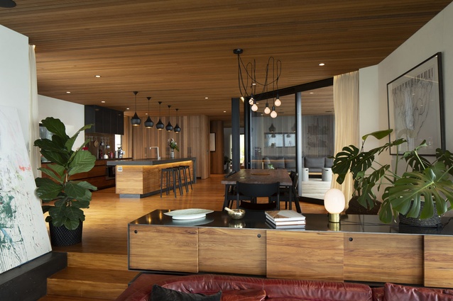 Recycled heart Rimu is used for the kitchen and dining floorboards, which, paired with the warm cedar walls, gives the interiors a lived-in feel.