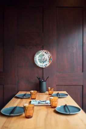 The original timber-panelled walls were retained and stained walnut, giving the space the sense of an ancient wooden box.