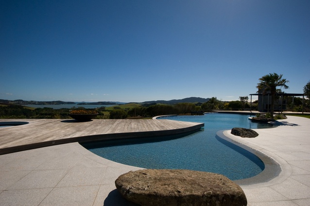 The poolscape is enhanced by salt and pepper granite coping stones and pavers.