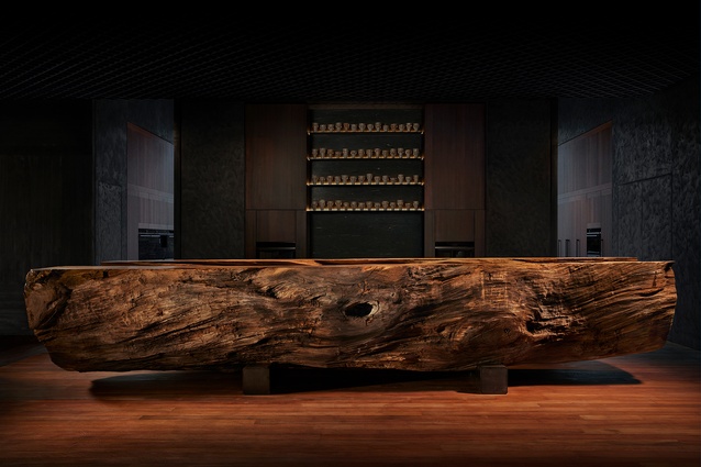 A monumental and sculptural trunk of swamp kauri rests within the Auckland Experience Centre. The 4,000-year-old log has been split lengthwise to reveal the contours of its natural carved centre.