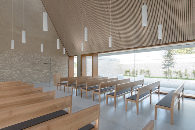 Ingleheim funeral chapel. The simple but bright interior is dignified and appropriate to its purpose, and features a gable roof.
