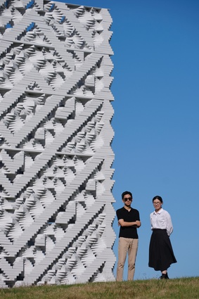 Team members Raymond Yoo and Rita Cai stand beside the six-metre-tall folly.
