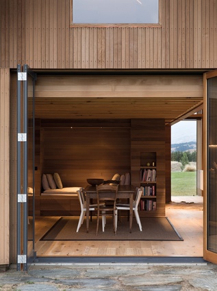 The original barn doors and a set of double-glazed bifold doors open the dining room/kitchen to the landscape. 