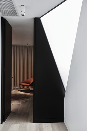 A triangular frosted window on the upper level adds natural light and a touch of drama.