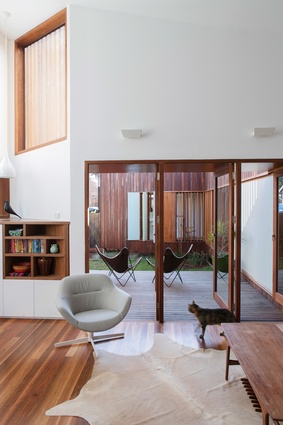 The sitting area of the main living space opens to a generous north-facing deck in the front garden.