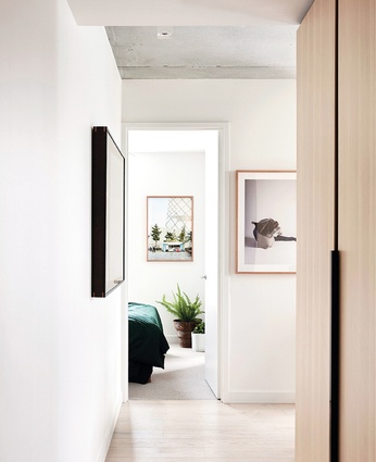 The two-bedroom apartment’s spatial quality and materials indicate the approach taken to interior design throughout the building. Artworks (L-R): Tom Ross, Anne Ferran.