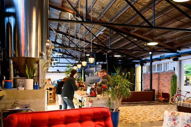 Brothers Brewery and Juke Joint in Auckland, New Zealand by MA Studio. The brewing facilities and bar are at the centre of the large warehouse space which breaks it up into more manageable zones.