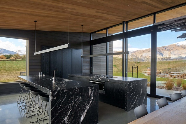 In a departure from the timber and concrete textures seen in the rest of the open plan living space, the kitchen features black titanium granite.
