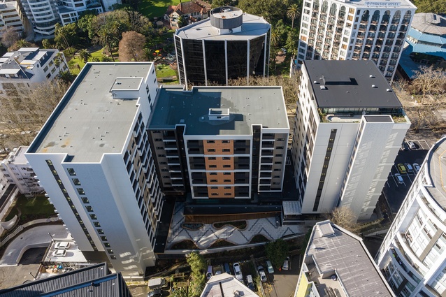 A rear view from above: the two social housing towers, Wainui and Waiora (Towers C and B), left and centre, terrace below and Waitapu (Tower A) to the right.