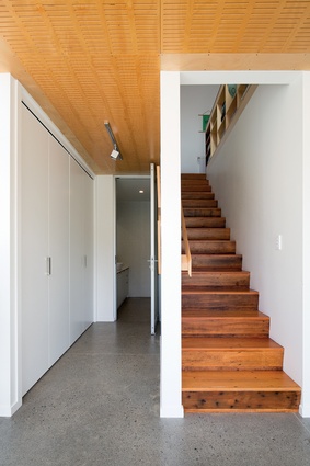 A recycled matai staircase lines the back of the kitchen bench.