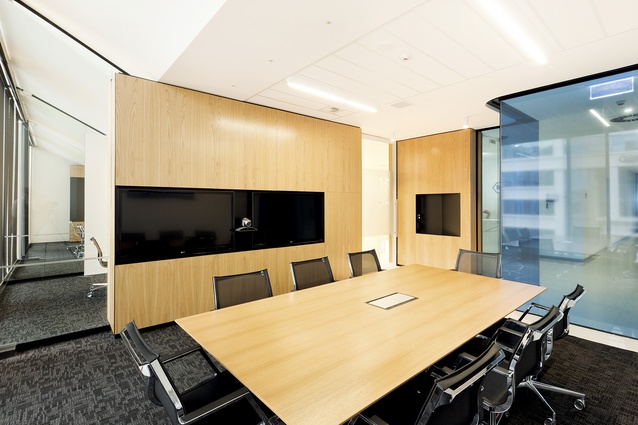 Lower level meeting rooms and boardroom, finished in oak, can be visually segregated by a ceiling-to-floor, rich-black curtain.