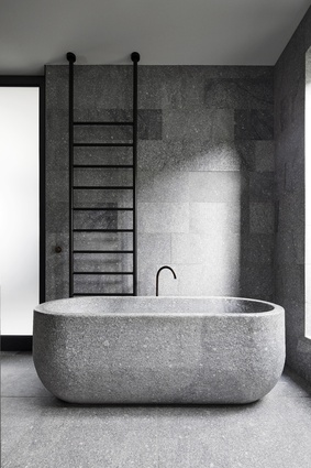The external palette continues inside, with granite floors and baths carved from solid stone.