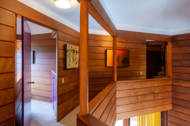 A mezzanine walkway leads to bedrooms and bathrooms, while allowing views back into the living areas.