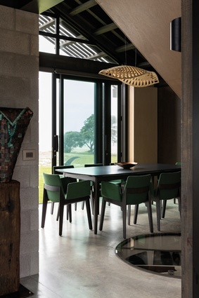 The Trio dining table by David Shaw is in stained Victorian ash, which matches the frameworks of the Capdell Ava dining chairs from UFL. Above the table is a Navicula pendant by David Trubridge.