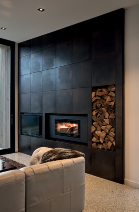 The dark living room wall balances visually with the views outside.
