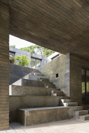 Rigidly composed, the Guna house is formulated as a series of 12 repetitive square volumes around a courtyard.