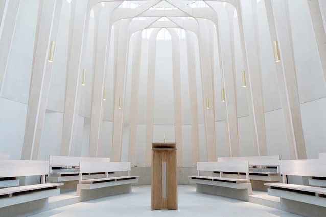 Bishop Edward King Chapel, UK, 2013. Slender timber columns create a dream-like sensation of being in a forest of tall trees, with the branches forming a latticed canopy overhead.