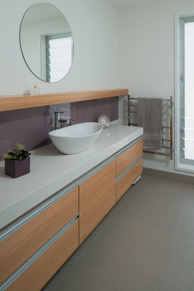For the main bathroom, Smith chose a vessel basin and darker accent colour for a more sophisticated look.