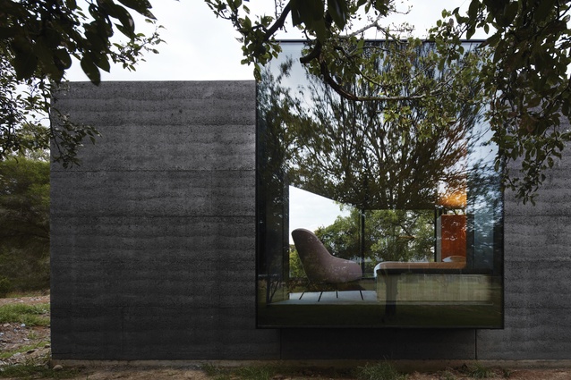  A large window box, extruding from the rammed-earth wall, frames views of the fruit trees and stables beyond.
