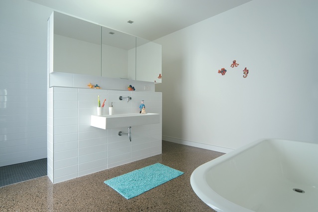 In the main bathroom, a freestanding pod separates the bath from the WC. A simple colour palette is used throughout the house.