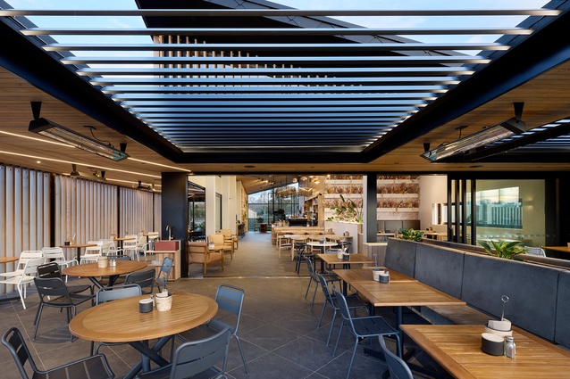 An indoor/outdoor dining room features adjustable ceiling louvres which can be opened up when the weather permits.