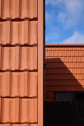 Exterior cladding is low-maintenance, affordable terracotta tiling.